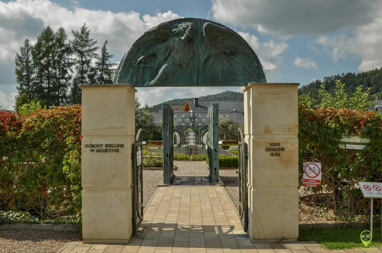 Brama do Ogrodów Biblijnych w Muszynie, idealne miejsce na weekendowe atrakcje. Monumentalny anioł nad wejściem zaprasza do zwiedzania.