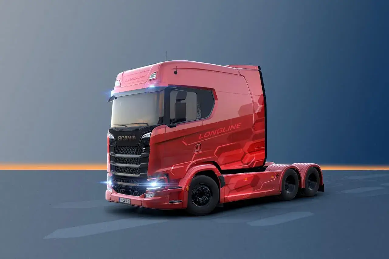 Un camion Scania 770 Longline rouge vif, avec des motifs hexagonaux sur la carrosserie, pr&ecirc;t pour de longues distances.