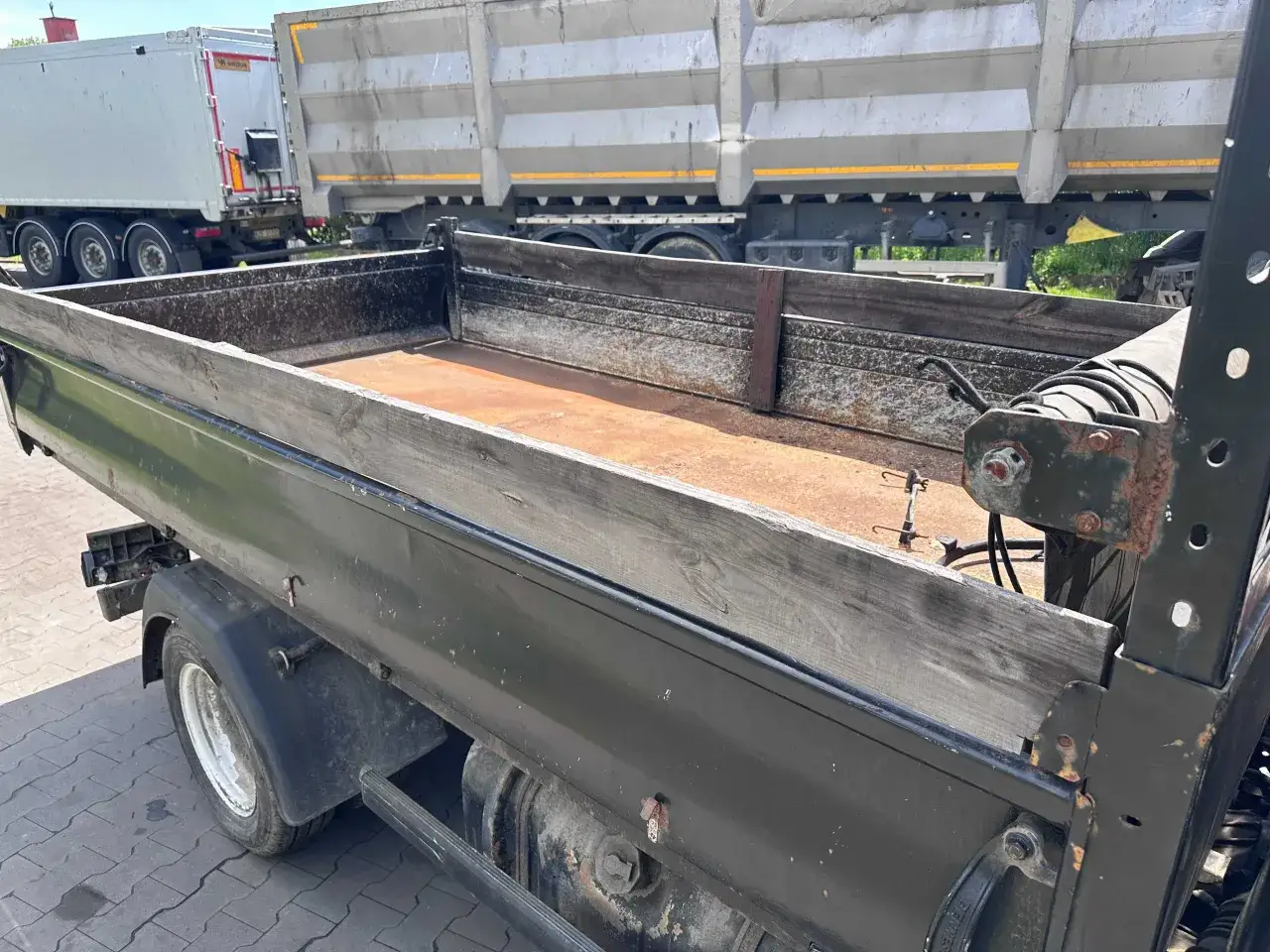 Potrzebny wynajem wywrotki do 3,5 tony? Zobacz tę solidną, używaną wywrotkę z drewnianymi burtami, idealną do transportu materiałów.