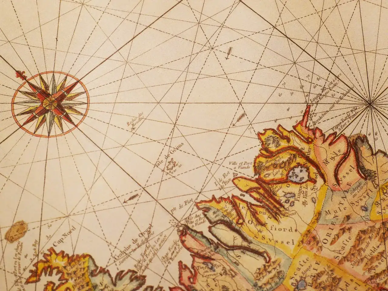 Rosa dei venti su antica mappa, con indicazioni di navigazione e terre. Il nord magnetico guida l'esploratore.