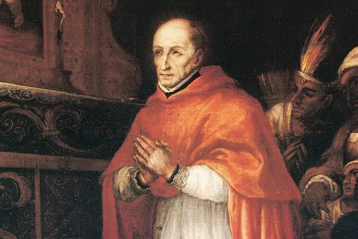 Retrato de **Santo Toribio de Mogrovejo**, arzobispo, con las manos juntas en oración. A su lado, figuras con vestimentas indígenas.