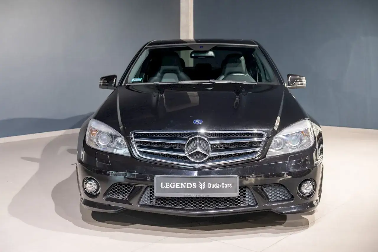 Czarny Mercedes C63 AMG W204 z charakterystycznym grillem i reflektorami, gotowy do jazdy.