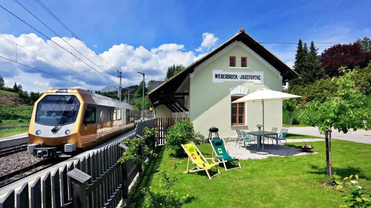 Goldener Zug f&auml;hrt am Bahnhof Wienerbruck-Josefsberg ein. Perfekt f&uuml;r einen Urlaub ohne Auto, mit Liegest&uuml;hlen und Grill.