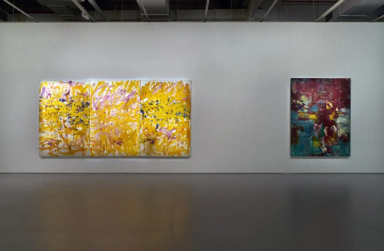 Abstract paintings by Megan Rooney hang on a white gallery wall.