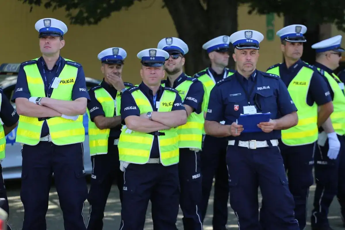 Grupa policjantów w kamizelkach odblaskowych. Chcesz wiedzieć, jak dostać się do drogówki? Ci funkcjonariusze wiedzą, jak dbać o bezpieczeństwo na drogach.