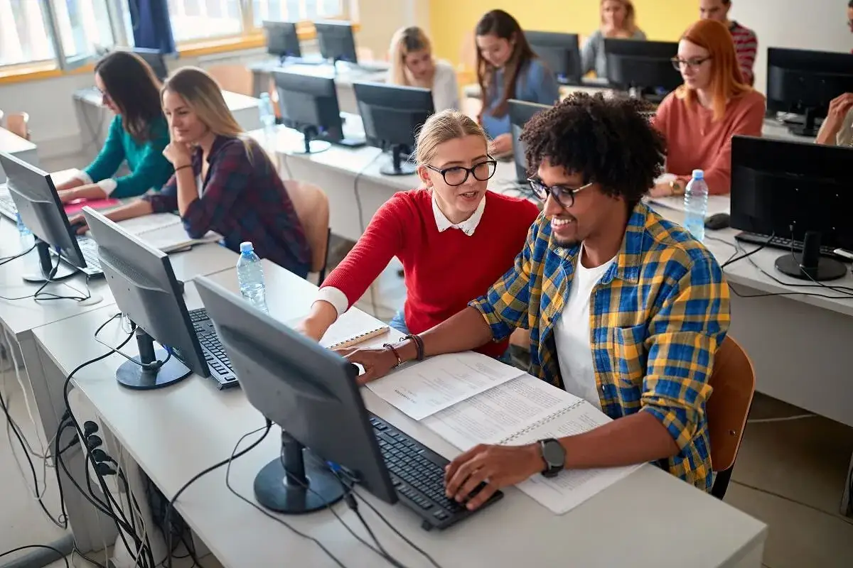 Des &eacute;tudiants travaillent sur leurs ordinateurs, certains collaborent. L'un d'eux semble suivre un cours de master informatique &agrave; distance.