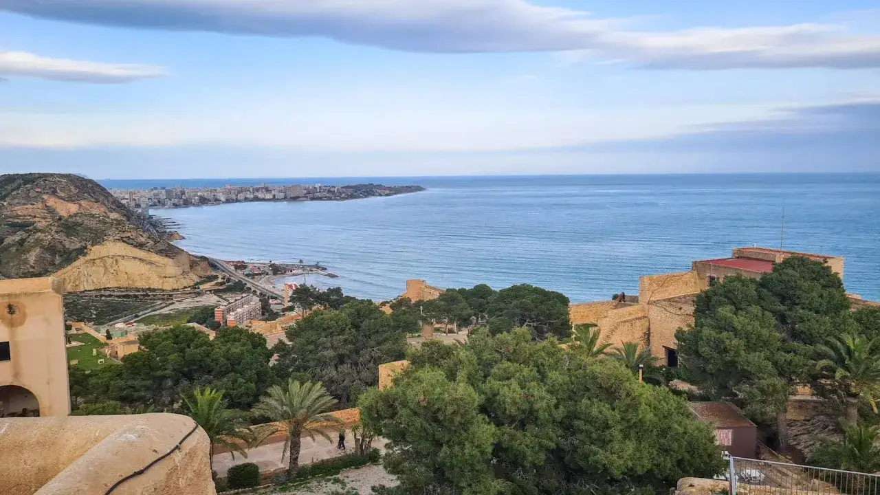 Vista panorámica de Alicante desde el castillo, con el mar azul y la ciudad al fondo. Un lugar ideal para disfrutar con niños.