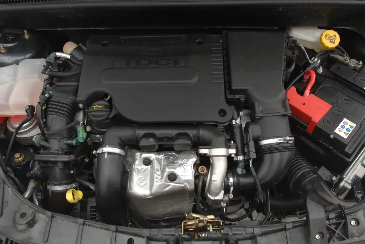 Silnik Ford Focus MK2 1.6 TDCI. Widoczny turbosprężarka, akumulator i elementy układu dolotowego.