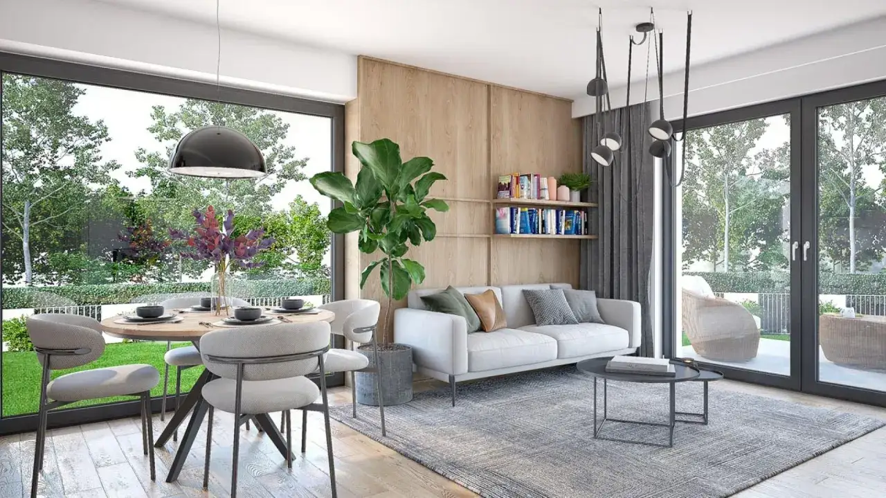 Nowoczesne wnętrze domu 70m2: salon z jadalnią, biała sofa, okrągły st&oacute;ł, duże okna z widokiem na ogr&oacute;d.