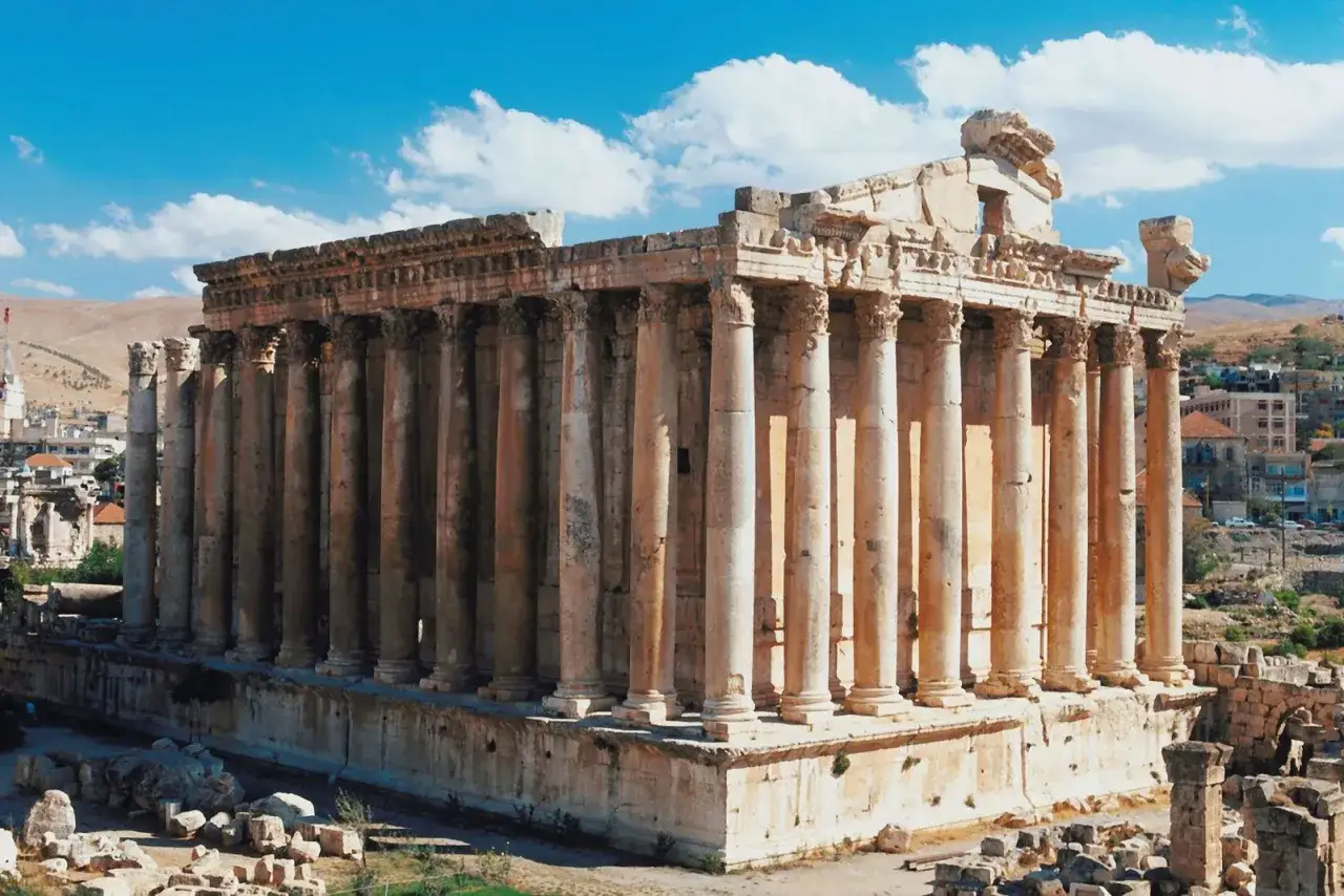 Majestic Roman ruins in Lebanon stand tall under a blue sky. These ancient structures, with their towering columns, whisper tales of a bygone era.