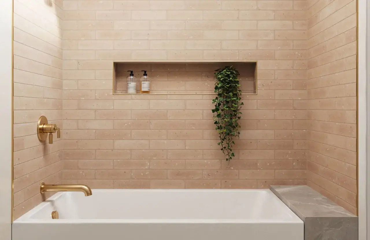 Warm, textured subway tile design ideas for a modern bathroom, featuring a built-in niche with toiletries and a trailing plant.