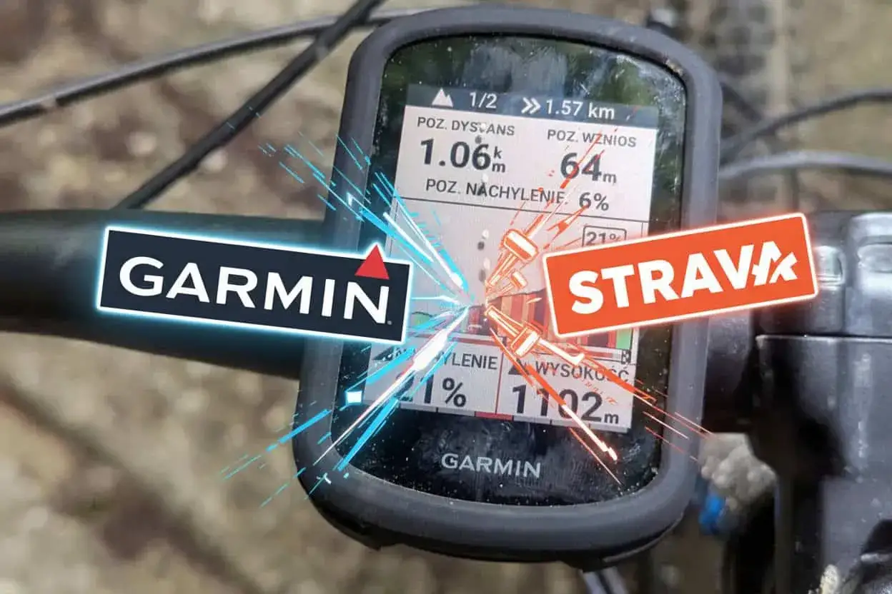 Na kierownicy rowerowej zamontowany jest licznik Garmin, pokazujący dane z trasy. Obok widnieje logo Strava, sugerujące integrację danych sportowych.