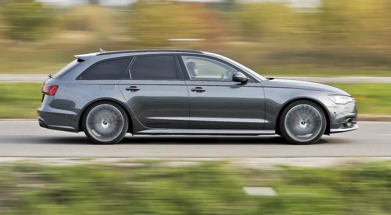 Szare Audi A6 C7 3.0 TDI Biturbo w wersji Avant pędzi po drodze. Nawet przy potencjalnych usterkach, jego moc robi wrażenie.