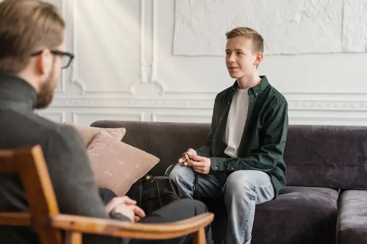 Ung man pratar med terapeut, som bedömer hans psykiska status.