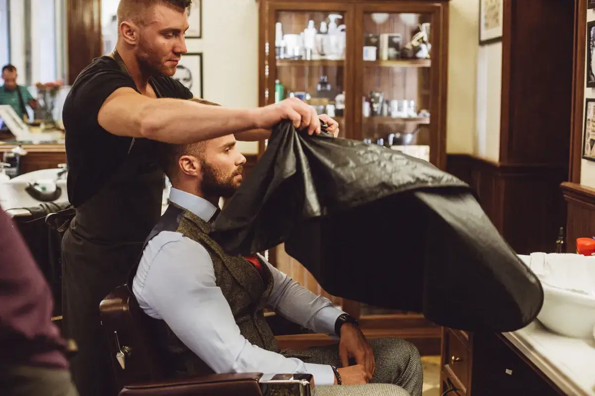 Mężczyzna zastanawiający się nad wizytą u barbera, z lekkim zarostem
