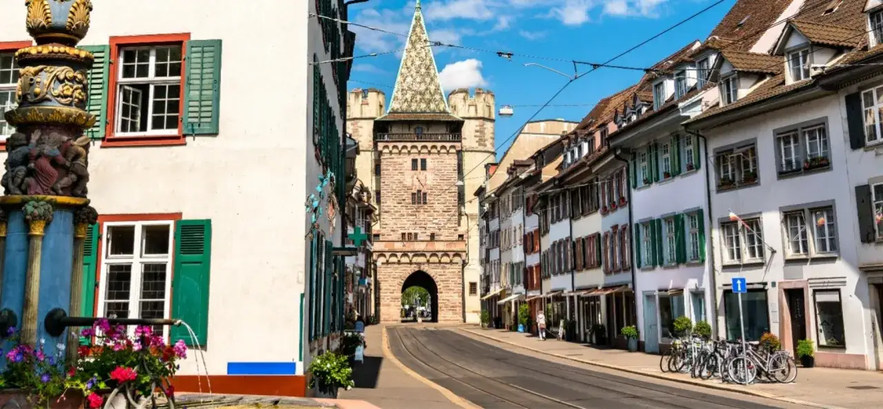 A charming street scene in Basel, perfect for a walking tour. This view captures the essence of a Basel itinerary with its historic architecture and tram tracks.