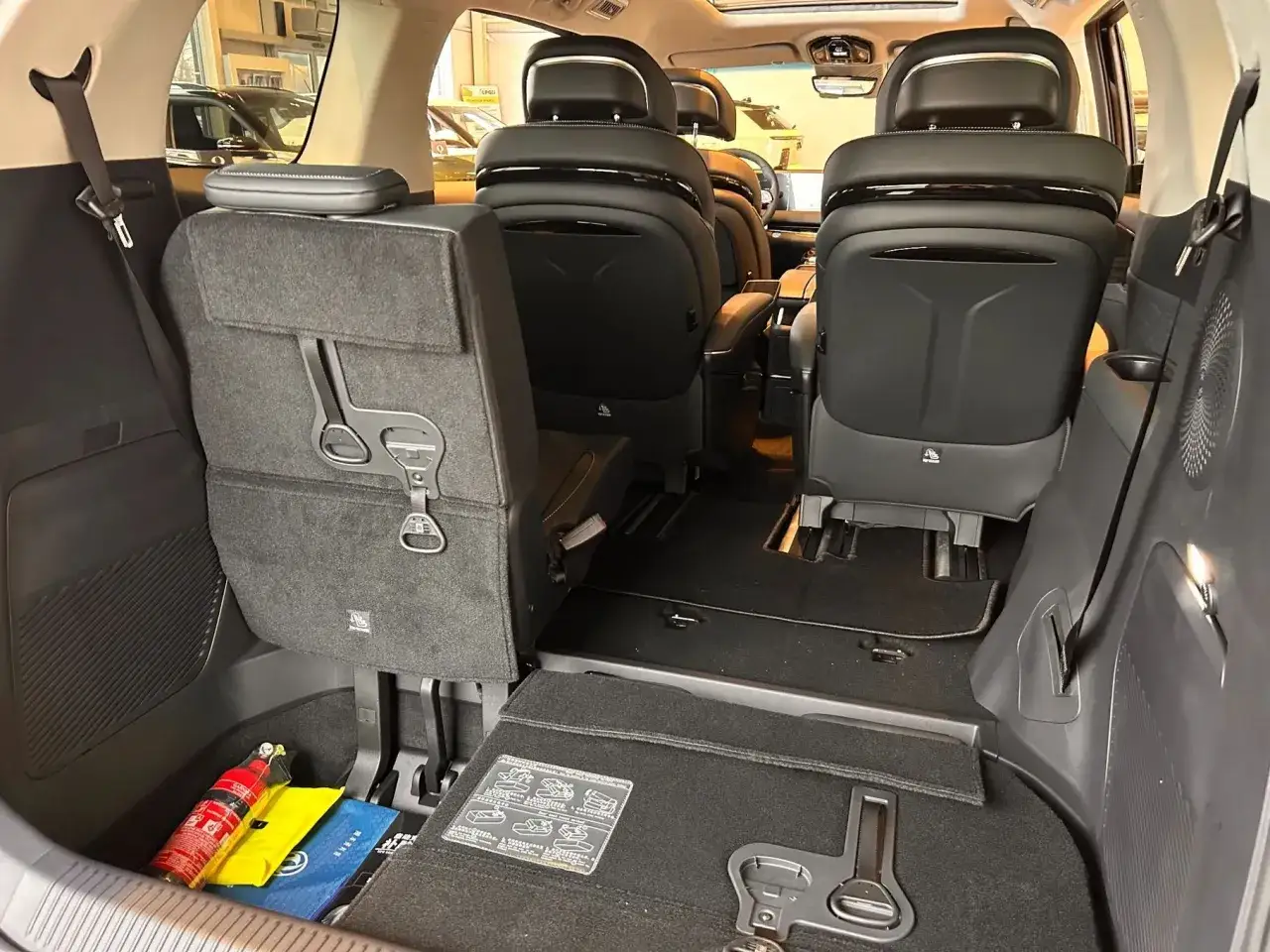 Wnętrze przestronnego SUV-a, gotowego na forting v tour. Widoczne wygodne fotele, schowki i gaśnica.