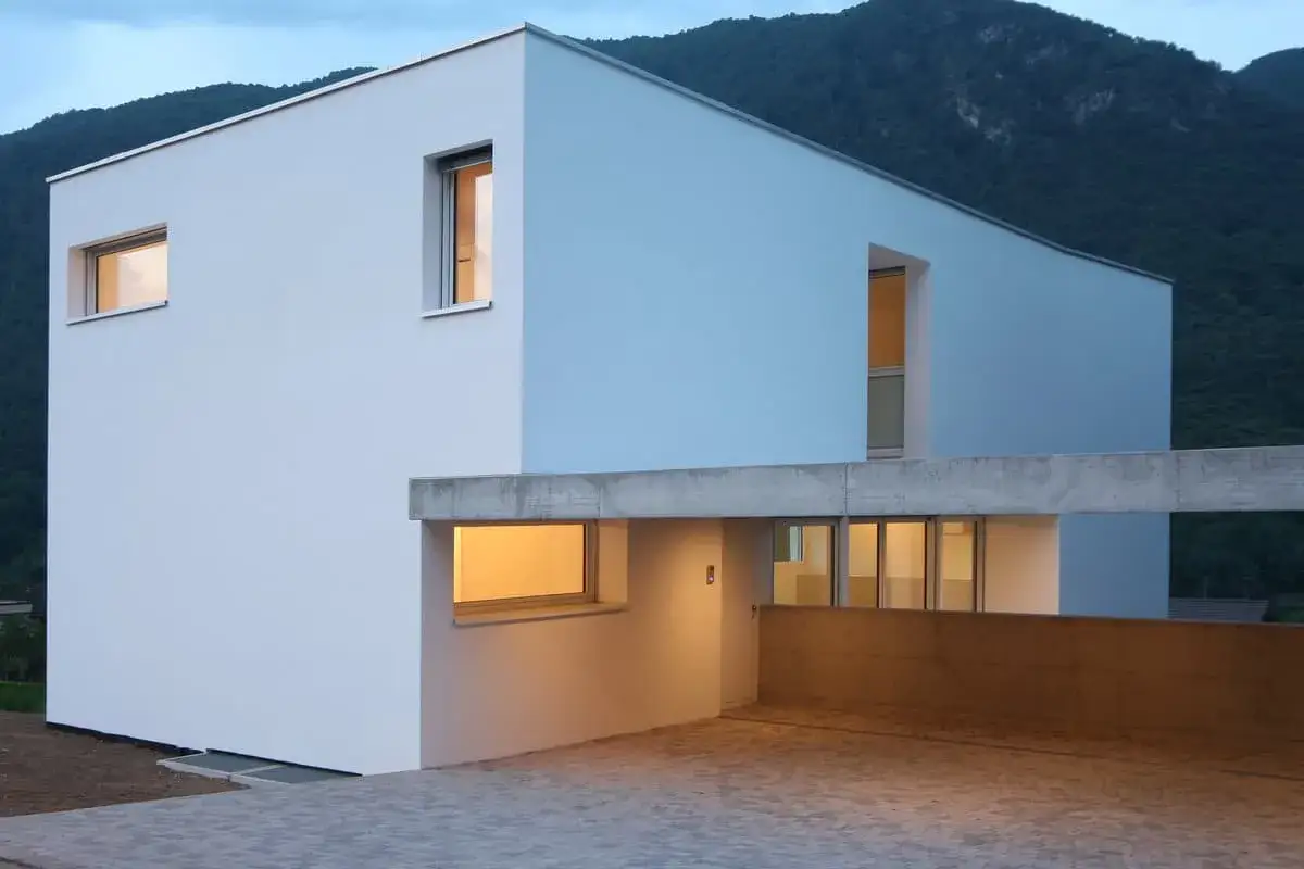 Maison moderne aux murs blancs et bleus, avec des fen&ecirc;tres lumineuses. Id&eacute;al pour estimer le prix cr&eacute;pi maison 200m2.