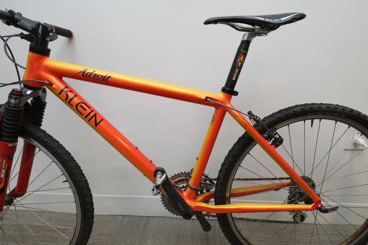 A vibrant orange and yellow gradient Klein Adroit mountain bike, ready for any trail.