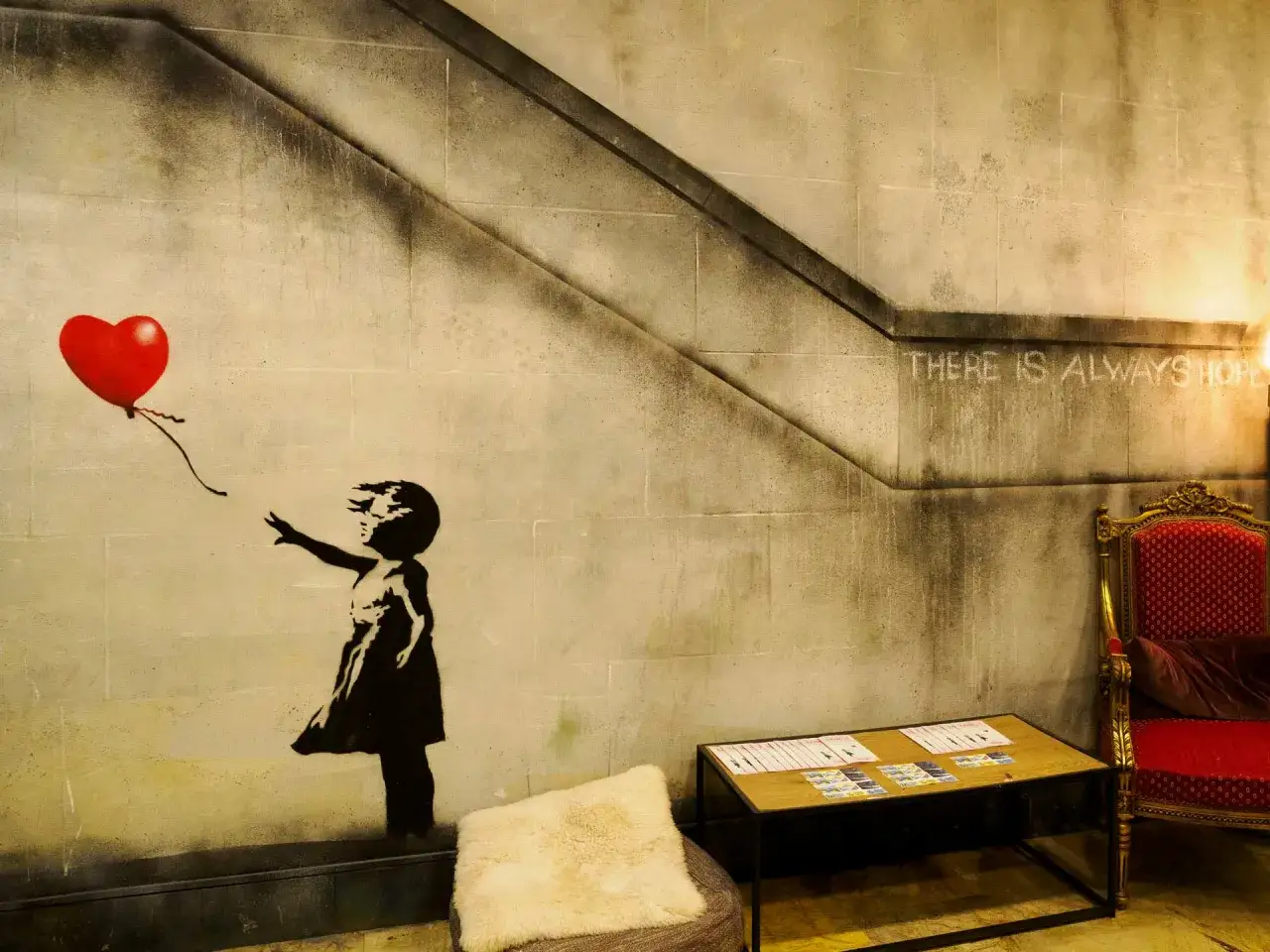 Le visage de l'artiste Banksy est ici repr&eacute;sent&eacute; par son &oelig;uvre iconique : une petite fille l&acirc;chant un ballon en forme de c&oelig;ur. 