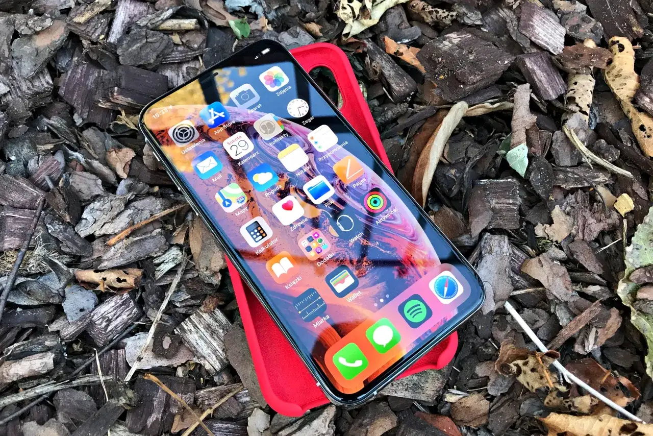 iPhone XS w czerwonym etui leży na korze. Zastanawiasz się, iphone xs do kiedy wsparcie?