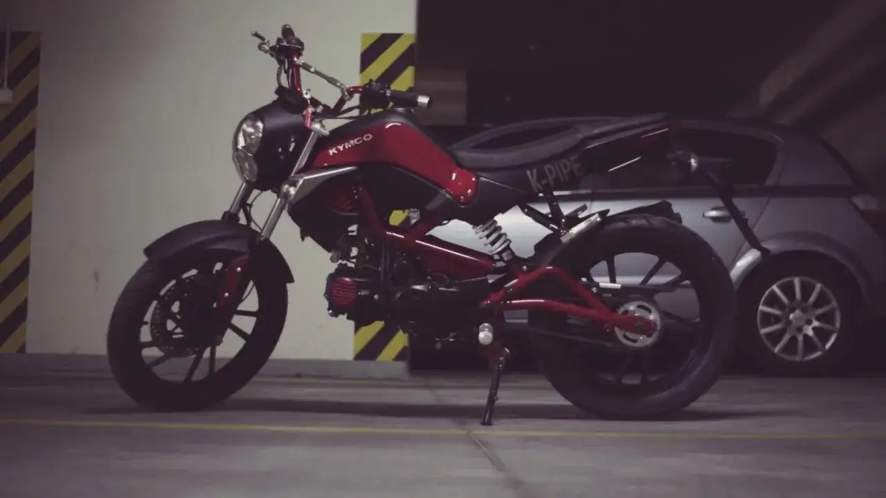 Czerwony skuter Kymco K-Pipe, idealny do nauki jak obliczyć stosunek mocy do masy.