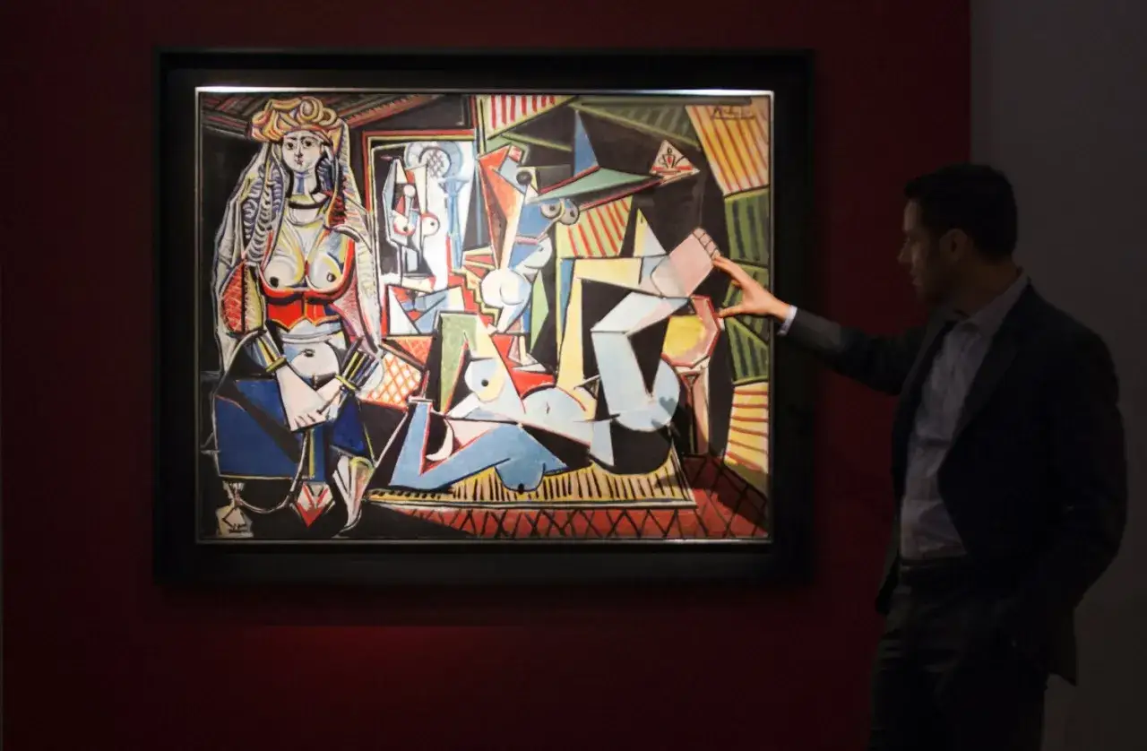 A man gestures towards Picasso's 