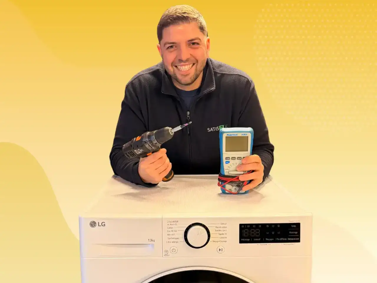 Un technicien souriant tient une perceuse et un multim&egrave;tre au-dessus d'une machine &agrave; laver LG. Il est pr&ecirc;t &agrave; r&eacute;parer votre machine qui n'essore plus.