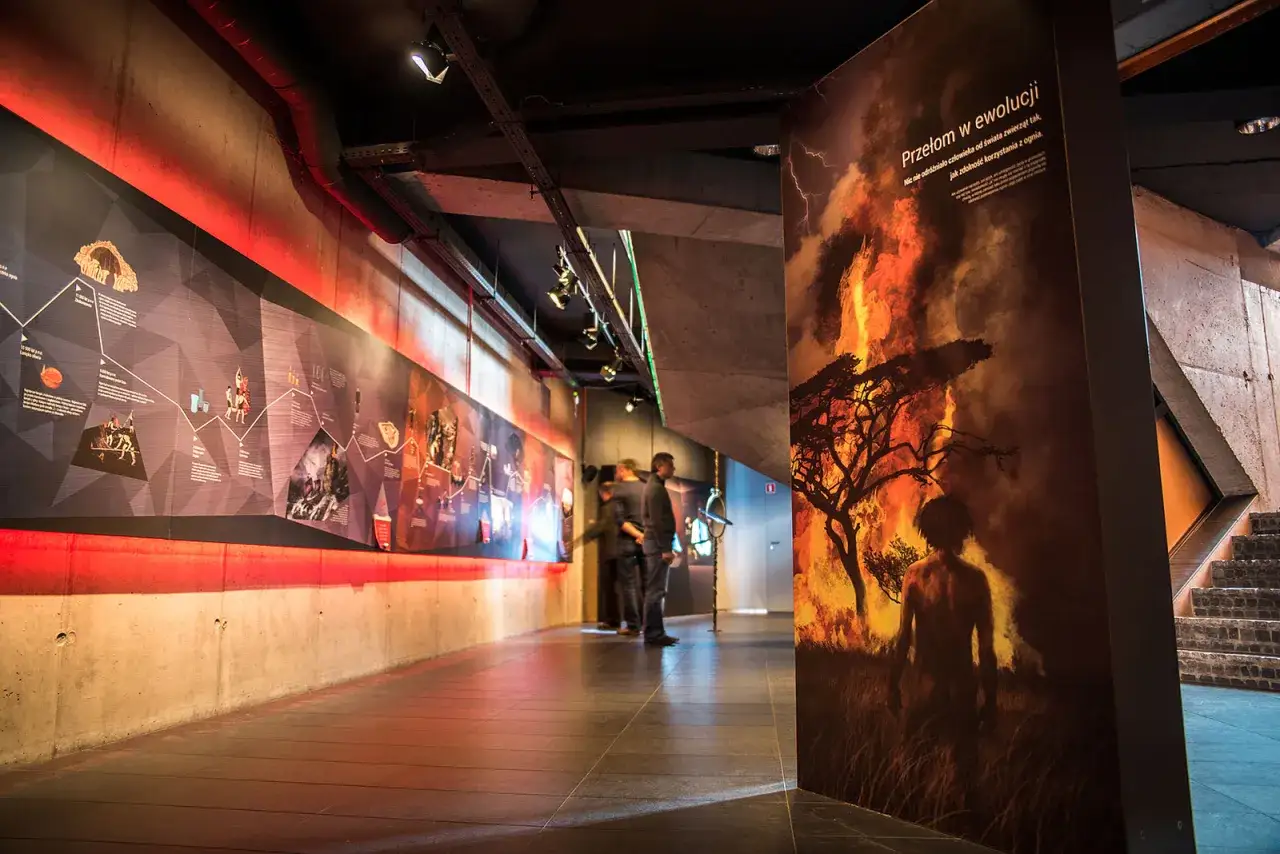 W muzeum ognia, na ścianie wielka grafika przedstawia człowieka stojącego przed płonącym drzewem. Obok, na długiej ekspozycji, historia ludzkości.