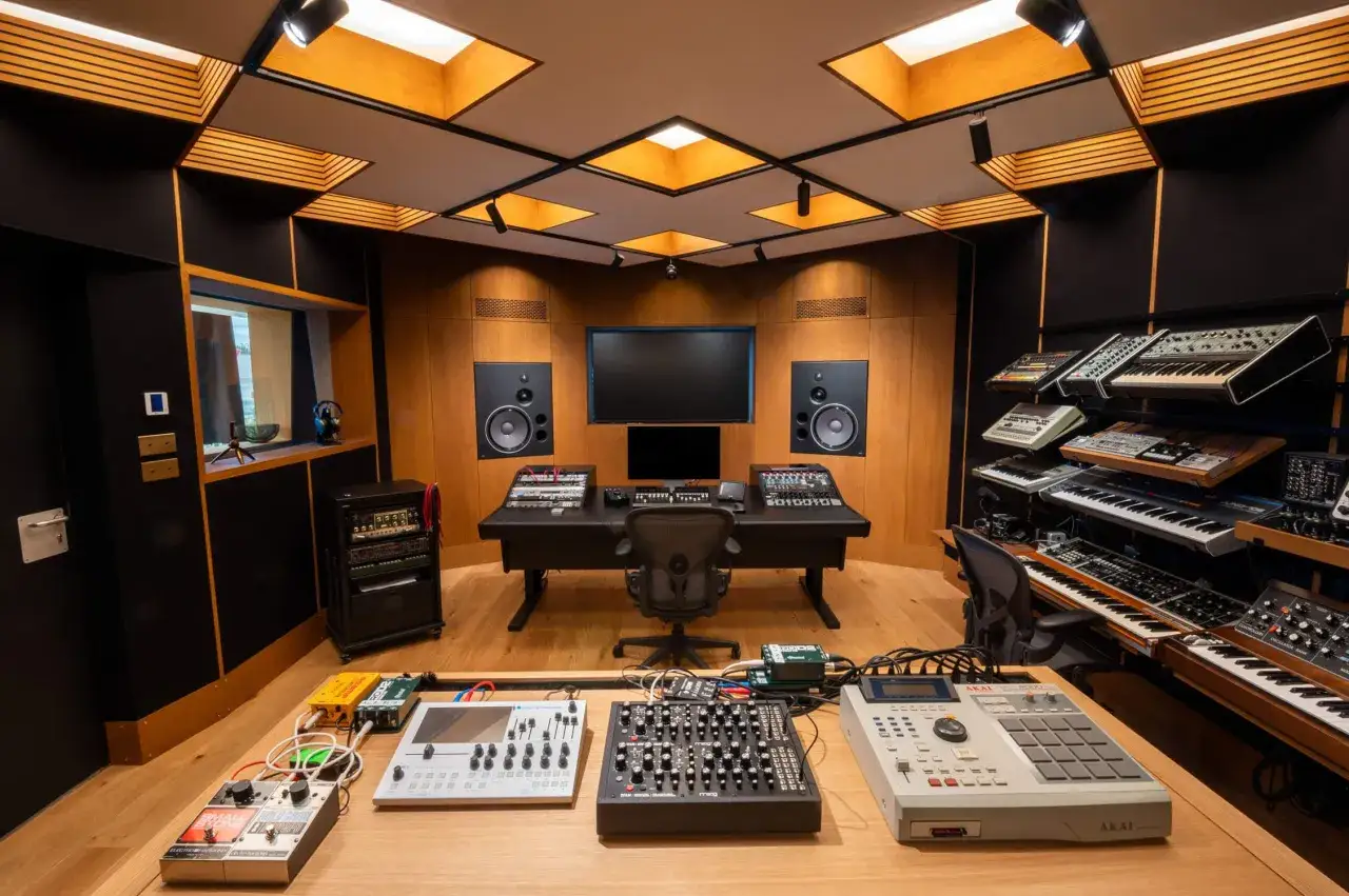 Studio d'enregistrement professionnel avec claviers, tables de mixage et matériel pour l'enregistrement sonore et l'édition musicale.