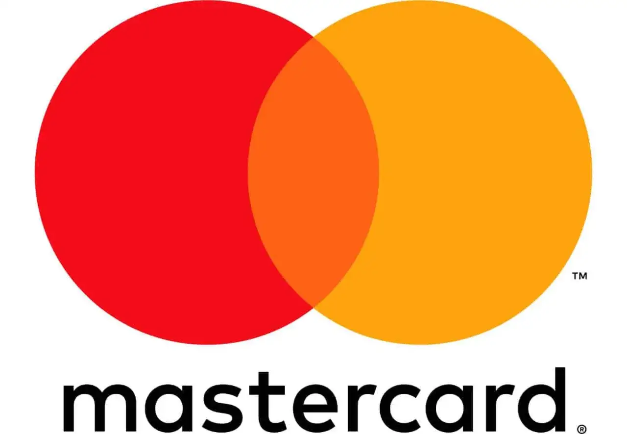 El logo de Mastercard España, con sus icónicos círculos superpuestos en rojo y naranja, simboliza la conexión y las posibilidades de pago.