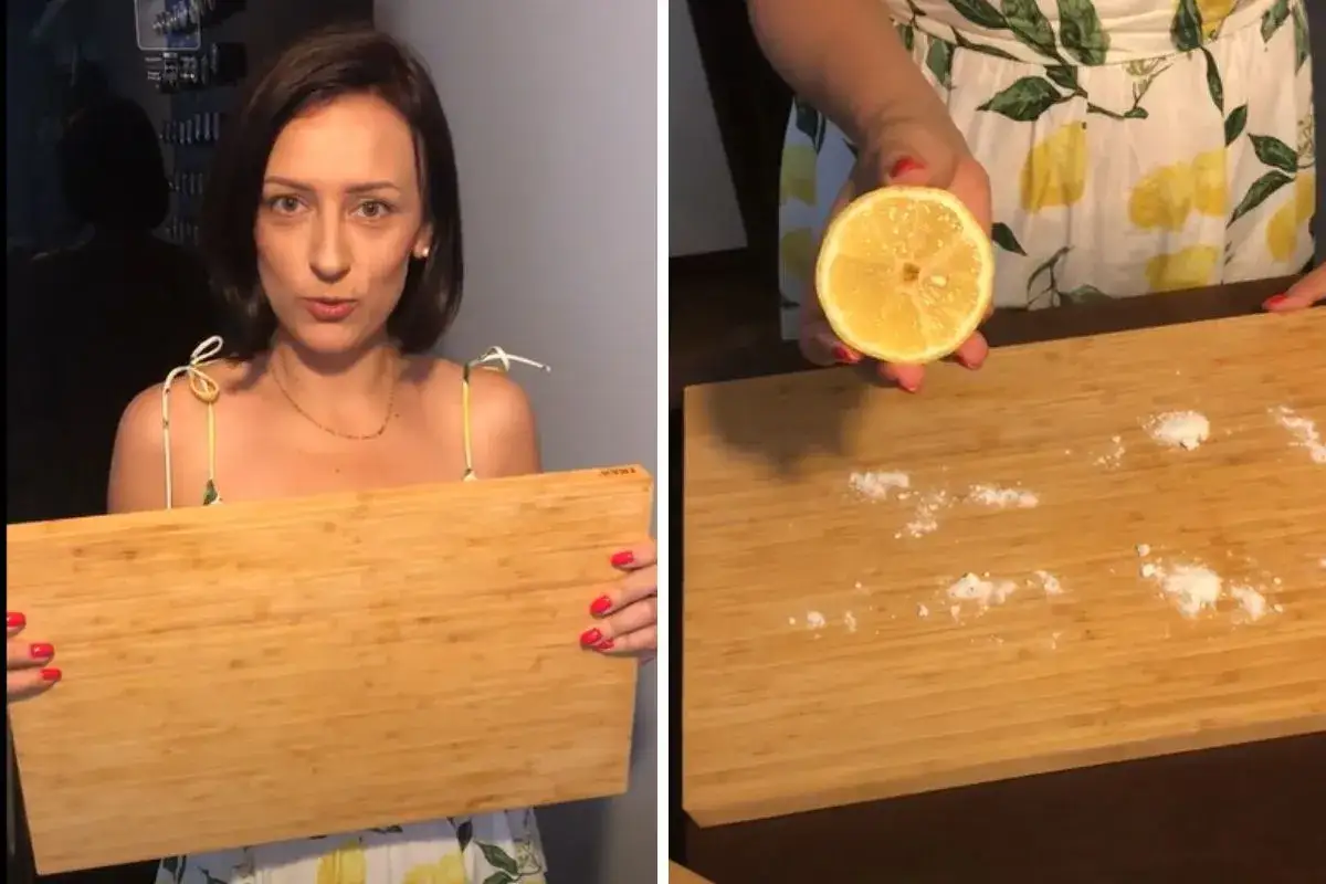 Kobieta pokazuje deskę do krojenia i połówkę cytryny z solą. To najskuteczniejsze metody na pozbycie się zapachu ryby z deski do krojenia.