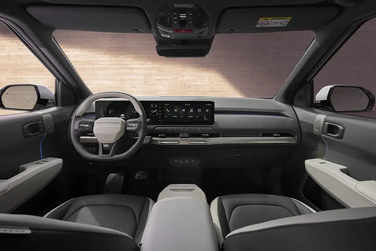 Interior del Kia EV3: volante moderno, pantalla t&aacute;ctil panor&aacute;mica y asientos c&oacute;modos.