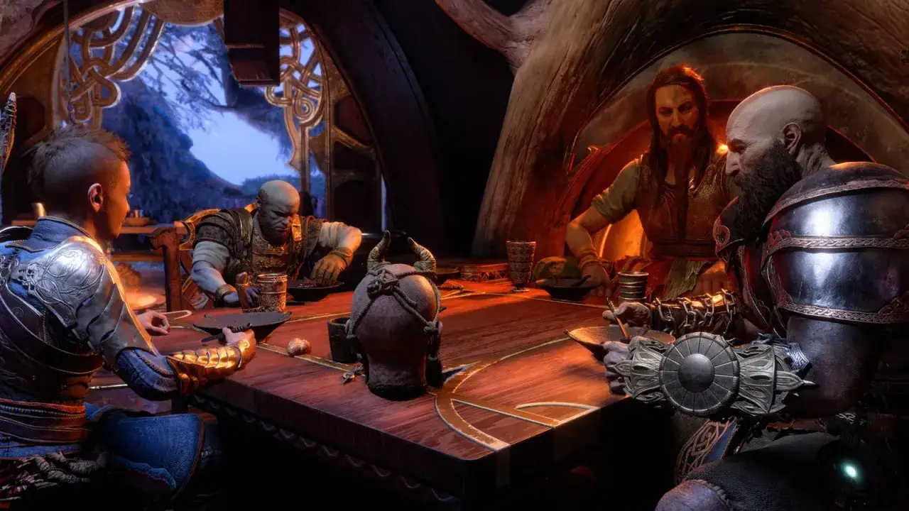 Czterech mężczyzn, w tym Kratos i Atreus, siedzi przy stole, jedząc. W tle widać okno z widokiem na zimowy krajobraz. Jeden z mężczyzn, być może ważny npc, opowiada historię.