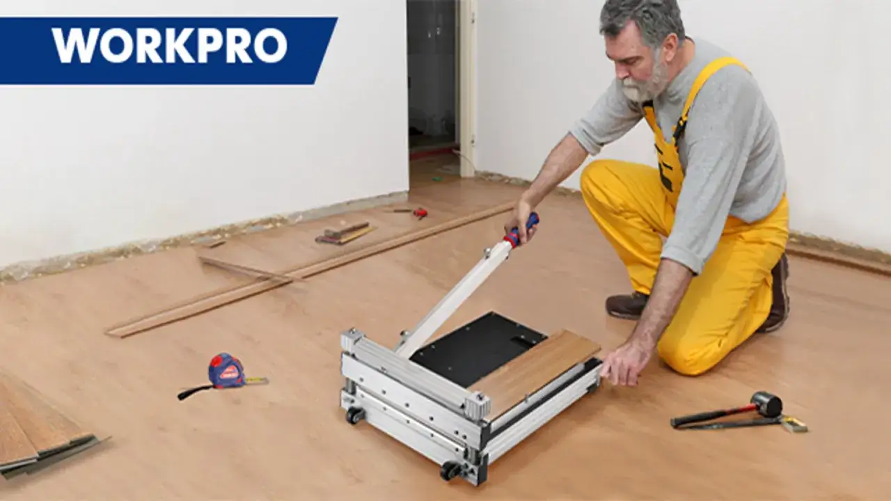 Man in yellow overalls uses a WORKPRO vinyl plank cutter to demonstrate how to cut vinyl plank flooring.