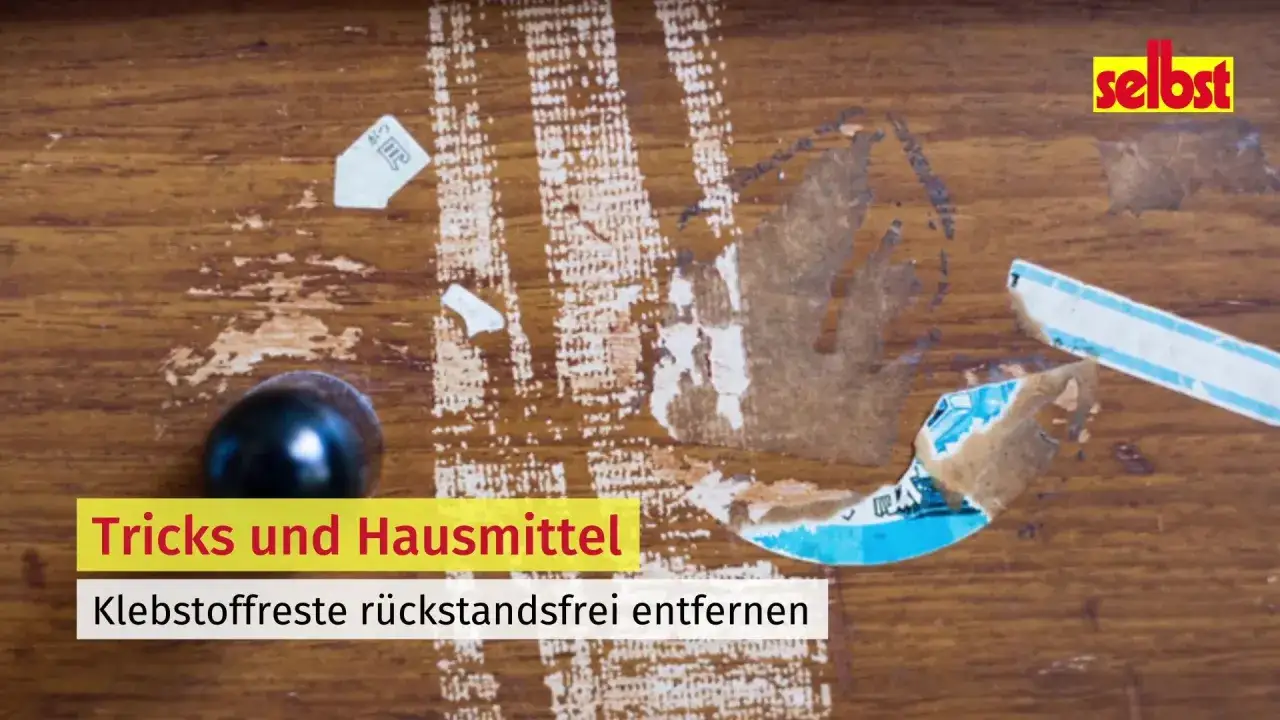 Holzoberfl&auml;che mit hartn&auml;ckigen Kleberesten. Hier werden Tricks und Hausmittel gezeigt, um Klebereste von Metall zu entfernen.
