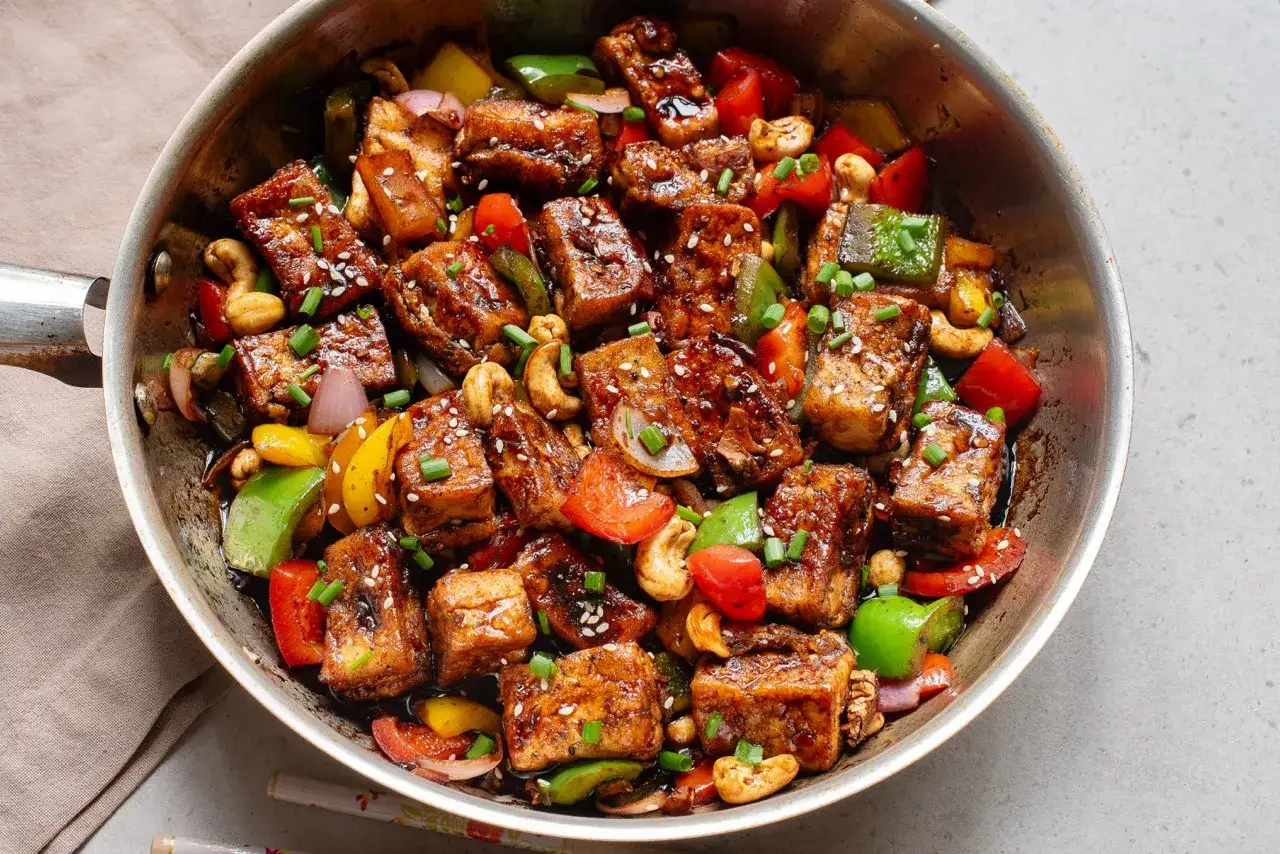 Tofu salteado con pimientos, cebolla, anacardos y semillas de sésamo. Una deliciosa forma de como cocinar tofu.