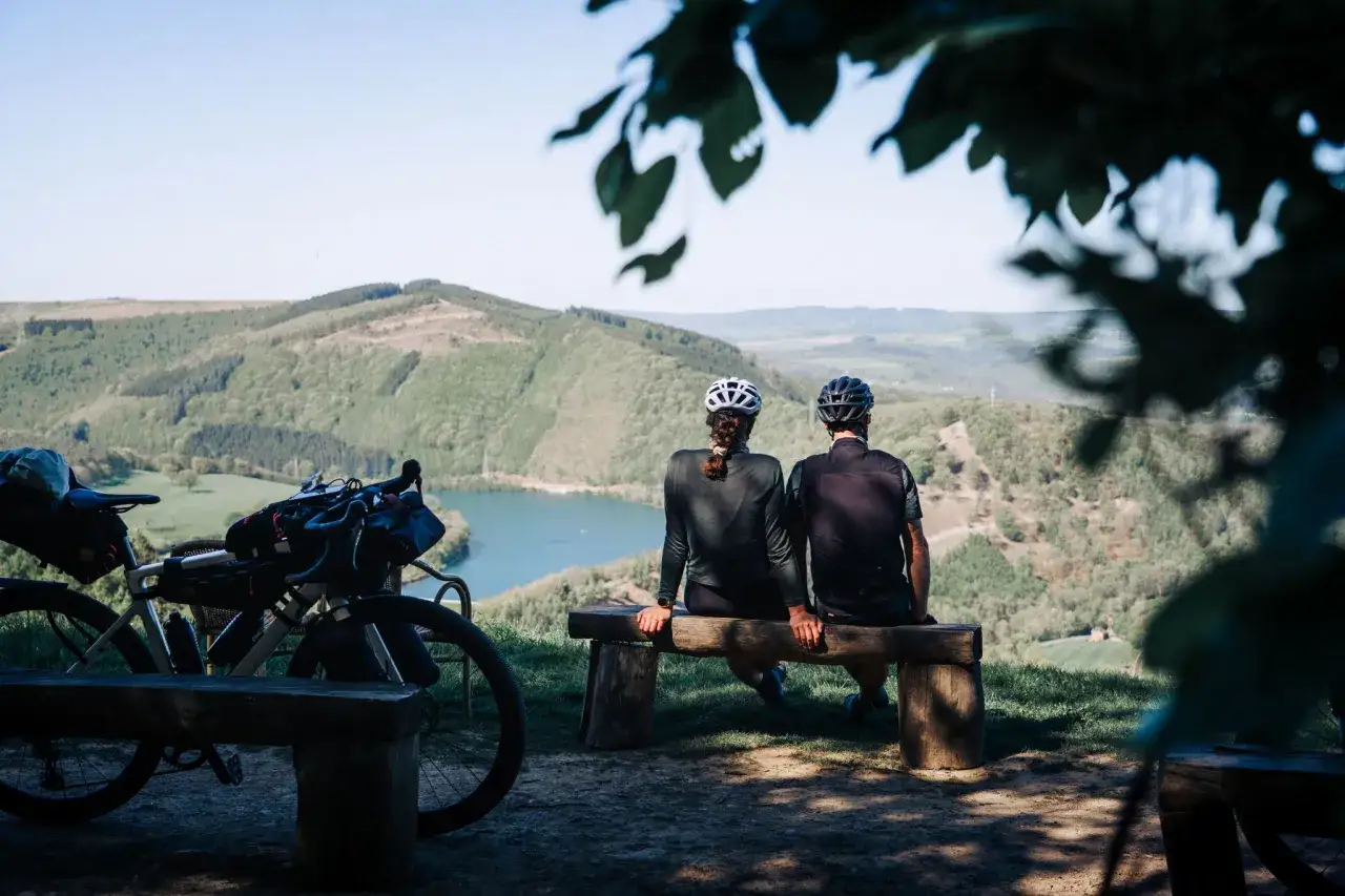 Zwei Radfahrer genießen die Aussicht auf einen See während ihres Bikepacking-Abenteuers in Deutschland.