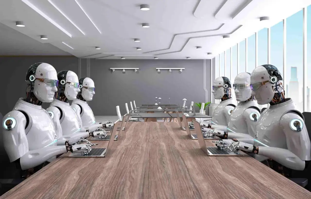 Robot in una sala riunioni, con laptop davanti a loro, un'immagine che evoca i lavori che scompariranno.