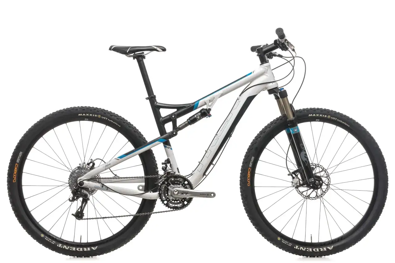 A white Gary Fisher HiFi Pro mountain bike with blue accents, featuring Maxxis Ardent tires and Fox suspension.
