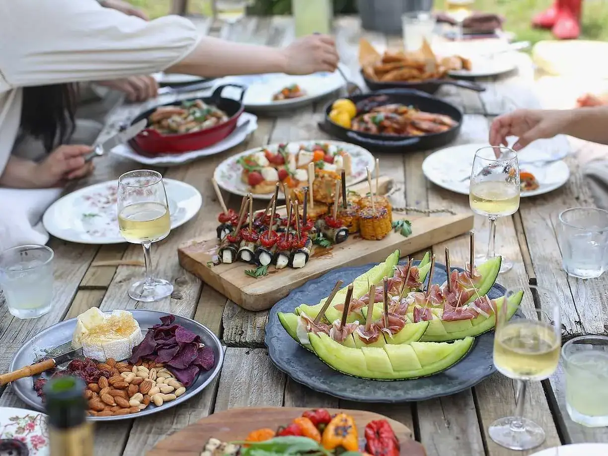 Studentmottagning med härlig studentmottagning mat: melon med prosciutto, grillad majs, ostbricka och vin.