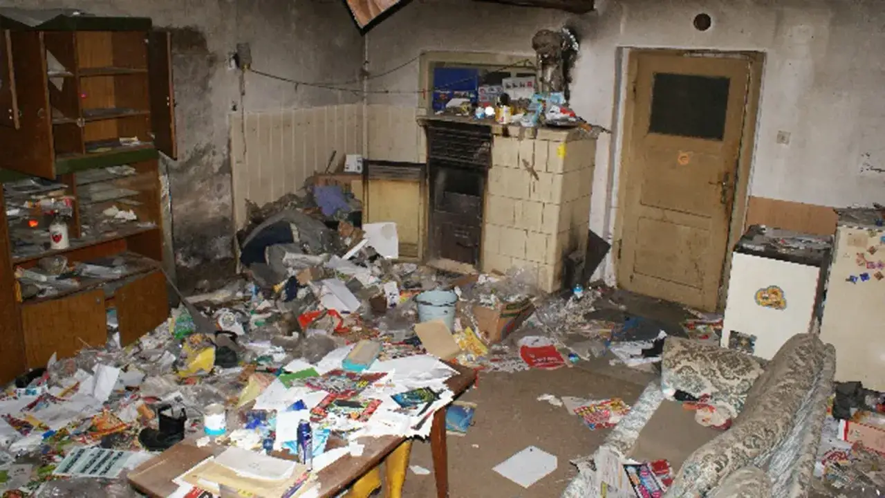 Chaotisches Zimmer voller Müll und Schmutz. Ein Beispiel für Mietbetrug durch Vermieter, die Wohnungen in solch einem Zustand vermieten.