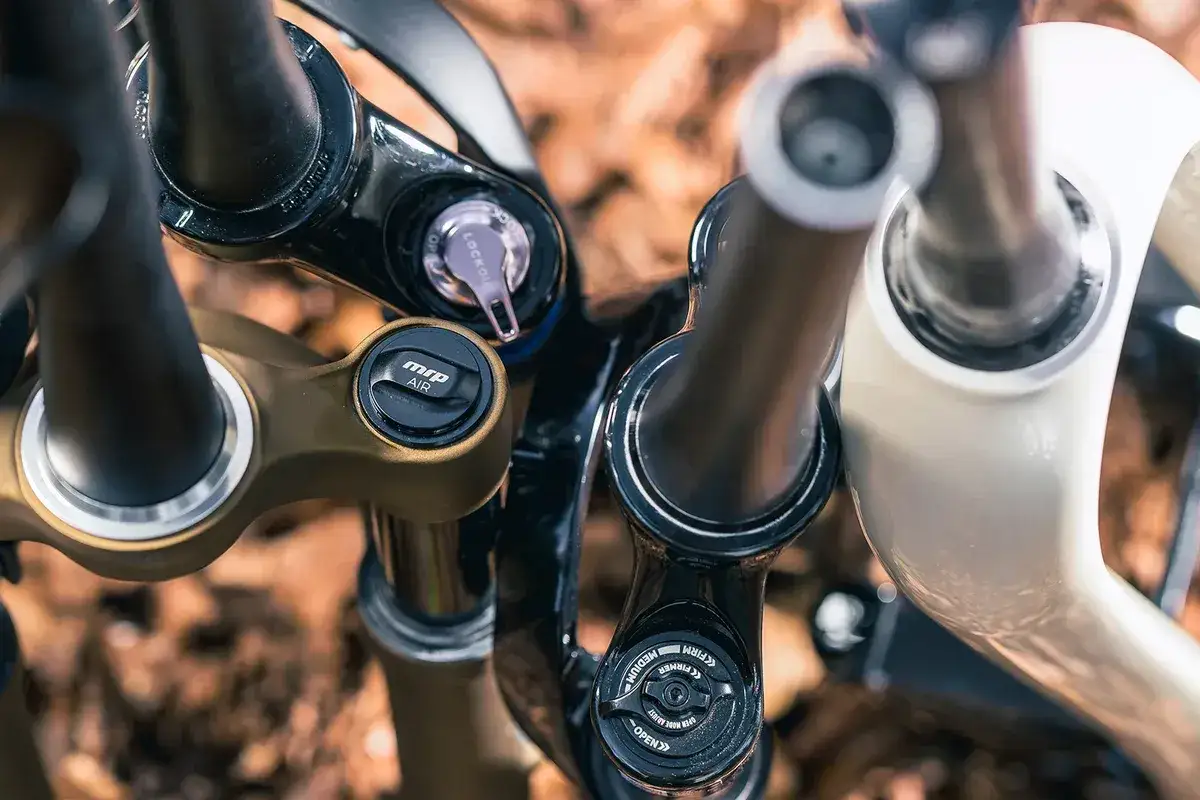 Close-up of several bicycle lauf fork crowns, featuring