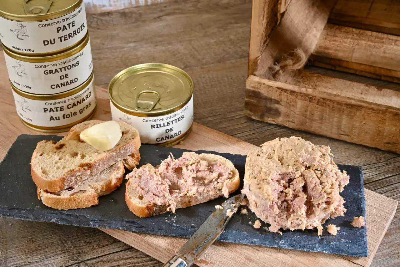Pâté de canard, rillettes et grattons en conserve, servis sur du pain. Une dégustation qui met en avant le foie gras vs pâté.