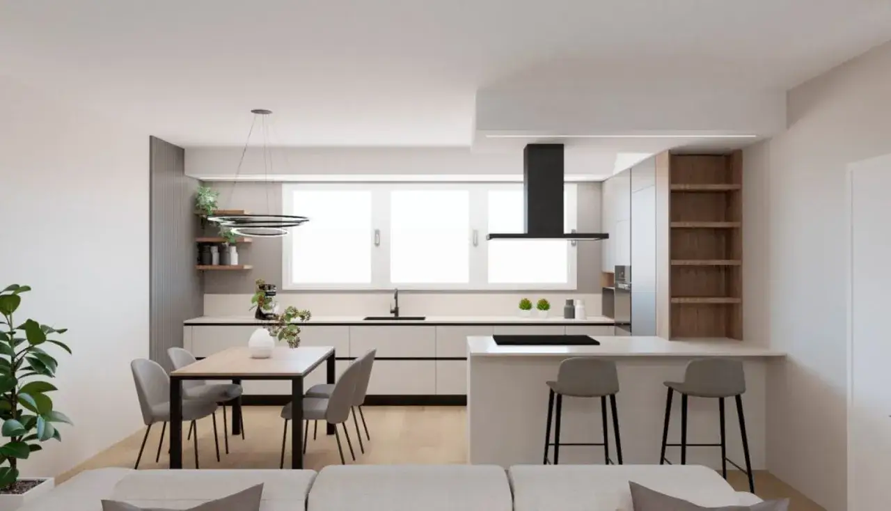 Elegante zona giorno open space con cucina moderna, isola con sgabelli, tavolo da pranzo e un accogliente salotto.