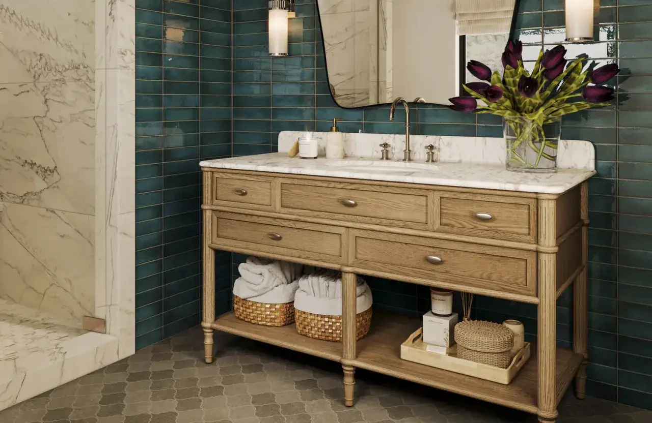 A classic wooden vanity with marble top, showcasing one of the many types of vanities. Teal subway tiles and a marble shower complete the luxurious bathroom.