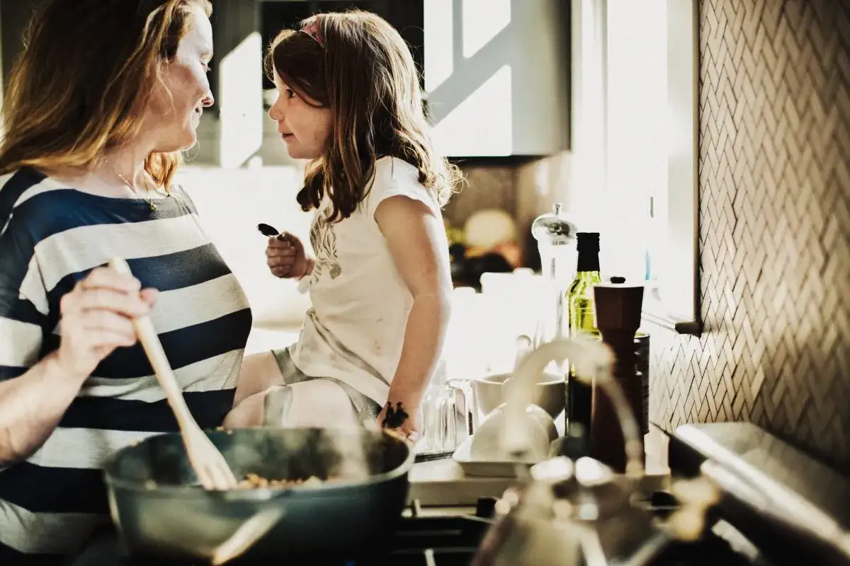 Madre e figlia in cucina, un momento sereno per mangiare e non ingrassare, senza stress.
