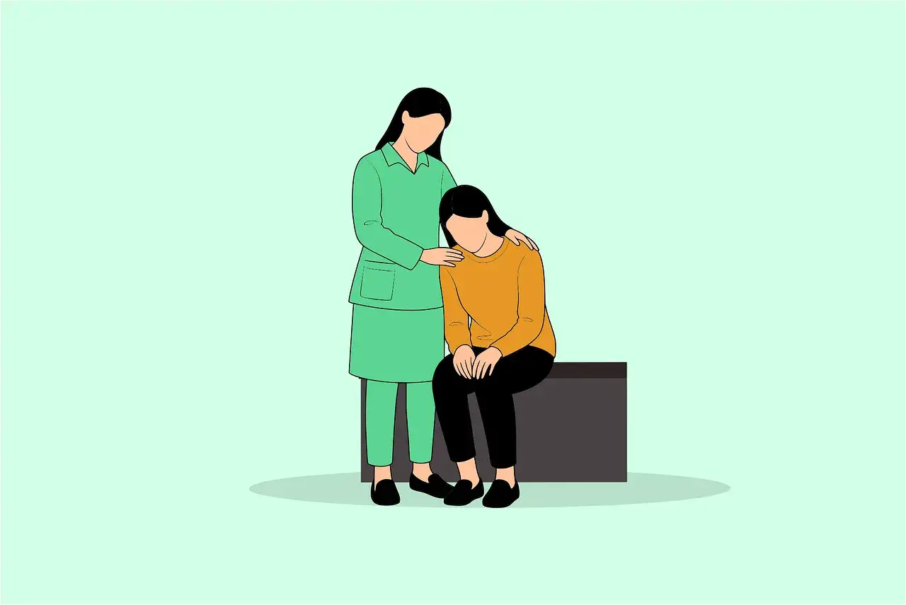 En person i grön uniform tröstar en annan person som sitter ned. Ett tydligt exempel på social intelligens och empati.