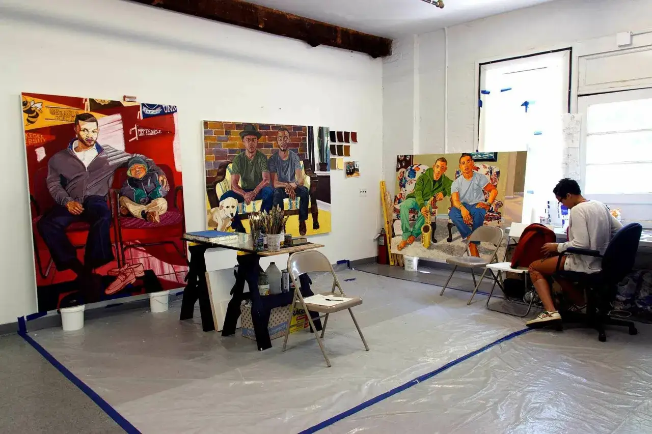 Artist's studio with large paintings of men and a dog, suggesting a future art gallery representation.