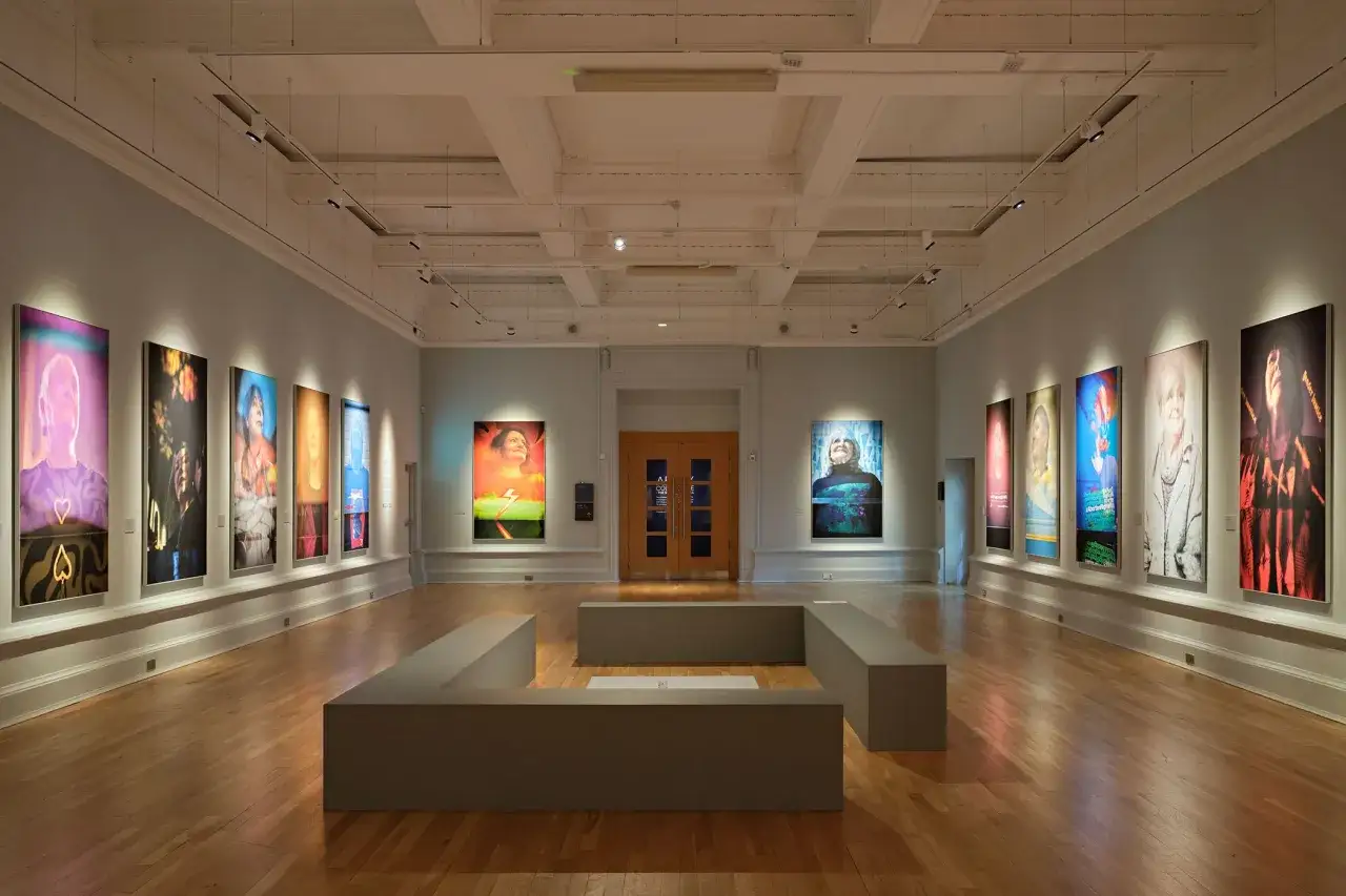 Vibrant portraits line the walls of a gallery space, showcasing diverse subjects. This striking exhibition is part of the Belfast Photo Festival.